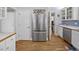 Kitchen view with stainless fridge and a doorway to other rooms at 25541 Troon Ave, Sorrento, FL 32776