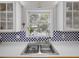 A bright kitchen view of window and the undermount stainless kitchen sink at 25541 Troon Ave, Sorrento, FL 32776