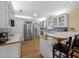 Traditional kitchen with white cabinets, stainless steel appliances and hardwood floors at 25541 Troon Ave, Sorrento, FL 32776