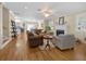 Open-concept living room featuring hardwood floors, a fireplace, and seamless access to the kitchen and dining area at 25541 Troon Ave, Sorrento, FL 32776