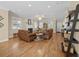 Large living room with hardwood floors, fireplace, and ample seating, ideal for gatherings and entertaining at 25541 Troon Ave, Sorrento, FL 32776