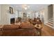 Comfortable living room with a fireplace, hardwood floors, and ample natural light, perfect for relaxation at 25541 Troon Ave, Sorrento, FL 32776