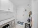 Bright mud room features white cabinetry, a desk, and convenient storage for organizing everyday essentials at 25541 Troon Ave, Sorrento, FL 32776