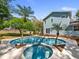 Backyard with a unique custom pool, spa and palm trees for ultimate relaxation and leisure at 25541 Troon Ave, Sorrento, FL 32776