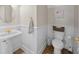 Elegant powder room with wainscoting, a pedestal sink, and modern fixtures, creating a sophisticated space at 25541 Troon Ave, Sorrento, FL 32776