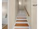 Wooden staircase features painted risers and a wooden handrail at 25541 Troon Ave, Sorrento, FL 32776