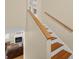 Wood staircase leads to a living room, and features wood handrail at 25541 Troon Ave, Sorrento, FL 32776