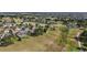 Aerial view of homes nestled around a golf course and pond at 2706 Radbourne Way, The Villages, FL 32162