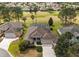 Beautiful aerial view of a well-maintained home featuring a screened pool and lush green landscaping at 2706 Radbourne Way, The Villages, FL 32162
