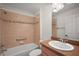 Bathroom featuring a shower-tub combo with decorative tile and a vanity with a sink at 2706 Radbourne Way, The Villages, FL 32162