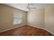 Bedroom featuring wood flooring, a ceiling fan, and a window with blinds at 2706 Radbourne Way, The Villages, FL 32162