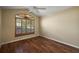 Bedroom with wood flooring, a large window with shutters, and natural light at 2706 Radbourne Way, The Villages, FL 32162