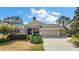 Charming home with manicured landscaping, double-door entry, and attached garage at 2706 Radbourne Way, The Villages, FL 32162