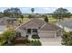 Charming single-story home with lush landscaping and a well-manicured lawn, showcasing its inviting curb appeal at 2706 Radbourne Way, The Villages, FL 32162