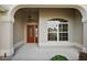 Inviting entryway featuring an arched porch, decorative front door, and sidelight window for natural light at 2706 Radbourne Way, The Villages, FL 32162