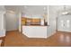 Kitchen featuring wood cabinets, a breakfast bar, and tile flooring, open to other living areas at 2706 Radbourne Way, The Villages, FL 32162