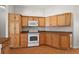 Kitchen showcasing ample cabinet space, modern appliances, and tile flooring for easy maintenance at 2706 Radbourne Way, The Villages, FL 32162