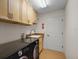 Laundry room with a washer and dryer, sink, storage cabinets, and tiled flooring at 2706 Radbourne Way, The Villages, FL 32162