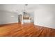 Bright and open living area showcasing hardwood floors, columns, and a view into the kitchen at 2706 Radbourne Way, The Villages, FL 32162