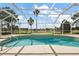 Screened-in pool offers a relaxing view of the golf course beyond at 2706 Radbourne Way, The Villages, FL 32162