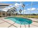 Relaxing screened pool with a great view of the lush, green yard and landscape at 2706 Radbourne Way, The Villages, FL 32162