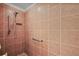 Tiled shower featuring a handheld shower head, a recessed shelf, and a grab bar at 2706 Radbourne Way, The Villages, FL 32162
