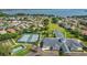 An aerial view shows many amenities, including a clubhouse, pool, shuffle board and tennis courts at 3584 Tropical Seas Loop, Tavares, FL 32778
