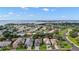 An aerial view shows a large waterfront community with lush landscaping and charming single-Gathering homes at 3584 Tropical Seas Loop, Tavares, FL 32778