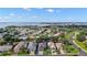 Aerial view of a waterfront community with lush landscaping and charming single-Gathering homes at 3584 Tropical Seas Loop, Tavares, FL 32778