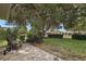 Lush backyard featuring a well-maintained lawn, mature trees, and manicured landscaping at 3584 Tropical Seas Loop, Tavares, FL 32778