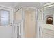 Bathroom featuring walk-in shower, towel rack, and white door at 3584 Tropical Seas Loop, Tavares, FL 32778