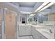 Bathroom with dual sinks, vanity, large mirror, walk-in shower, and tile flooring at 3584 Tropical Seas Loop, Tavares, FL 32778