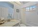 Well-lit bathroom featuring a shower-tub combo, marble vanity, and neutral color scheme at 3584 Tropical Seas Loop, Tavares, FL 32778