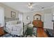 Bedroom featuring hard wood floors, ceiling fan, walk-in closet, and natural light from the windows at 3584 Tropical Seas Loop, Tavares, FL 32778