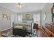 Bedroom with a large bed, hardwood floors, ceiling fan, and natural light from the windows at 3584 Tropical Seas Loop, Tavares, FL 32778