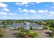 Community clubhouse with manicured landscaping and views of the lake, perfect for social gatherings at 3584 Tropical Seas Loop, Tavares, FL 32778