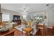 Spacious living room with hardwood floors, ceiling fan, and lots of natural light from windows at 3584 Tropical Seas Loop, Tavares, FL 32778