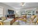 Open living room with hardwood floors, ceiling fan, and plenty of natural light at 3584 Tropical Seas Loop, Tavares, FL 32778