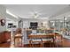 Open-concept living room with hardwood floors, ceiling fan, and access to the kitchen at 3584 Tropical Seas Loop, Tavares, FL 32778