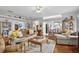 Comfortable living room featuring a ceiling fan, hardwood floors, and an open layout at 3584 Tropical Seas Loop, Tavares, FL 32778