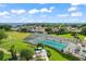 Community in-door pool with a translucent roof, blue umbrellas and plenty of tables overlooking the lake at 3584 Tropical Seas Loop, Tavares, FL 32778