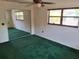 Spacious bedroom with mirror closet doors, a window and green carpet at 37 N Normandale Ave, Orlando, FL 32835