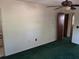 View of bedroom with green carpet, a ceiling fan, and a closet, providing a cozy space at 37 N Normandale Ave, Orlando, FL 32835