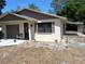 Street view of single-story home with a garage, landscaping, and covered side entrance at 37 N Normandale Ave, Orlando, FL 32835