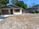 Street view of home with a garage, landscaping, and a covered side entrance at 37 N Normandale Ave, Orlando, FL 32835