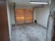 Interior view of attached garage with some items stored along the back wall at 37 N Normandale Ave, Orlando, FL 32835