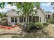 Home exterior showcasing the screened-in porch and backyard with mature landscaping, and a relaxing hammock at 38 Townhill Dr, Eustis, FL 32726