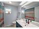 Well-lit bathroom featuring patterned shower curtain, and a single sink vanity at 38 Townhill Dr, Eustis, FL 32726