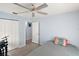 Well-lit bedroom showcasing neutral walls, a ceiling fan, closet and door to another room at 38 Townhill Dr, Eustis, FL 32726