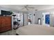 Bright bedroom with a large bed, a cat tree, and an open door to a bathroom at 38 Townhill Dr, Eustis, FL 32726